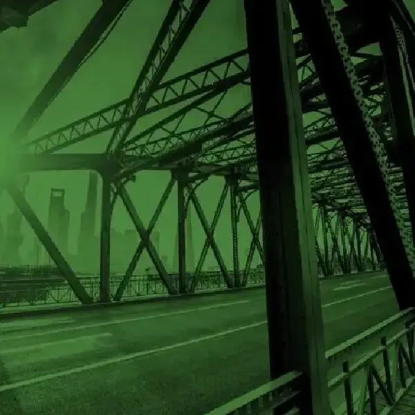 A bridge with green lights in the background